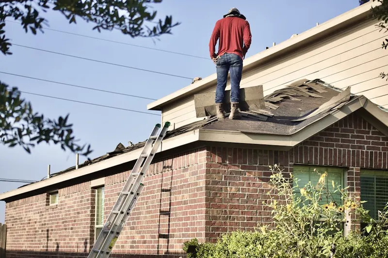 Professional roofer working on a residential roof in Crozierville